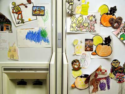 drawings hung on refrigerator